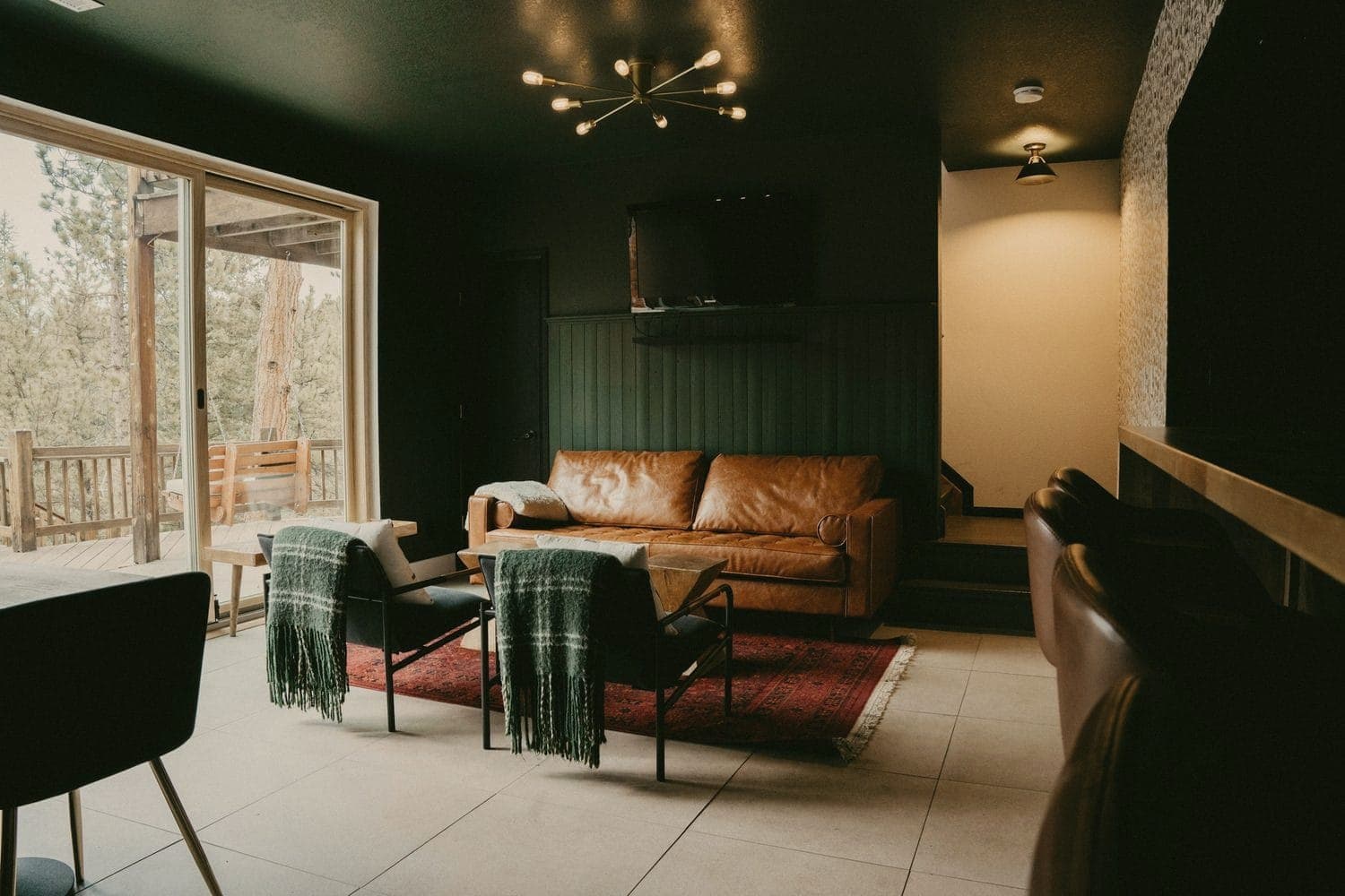 A living room with a leather sofa and a sliding glass door