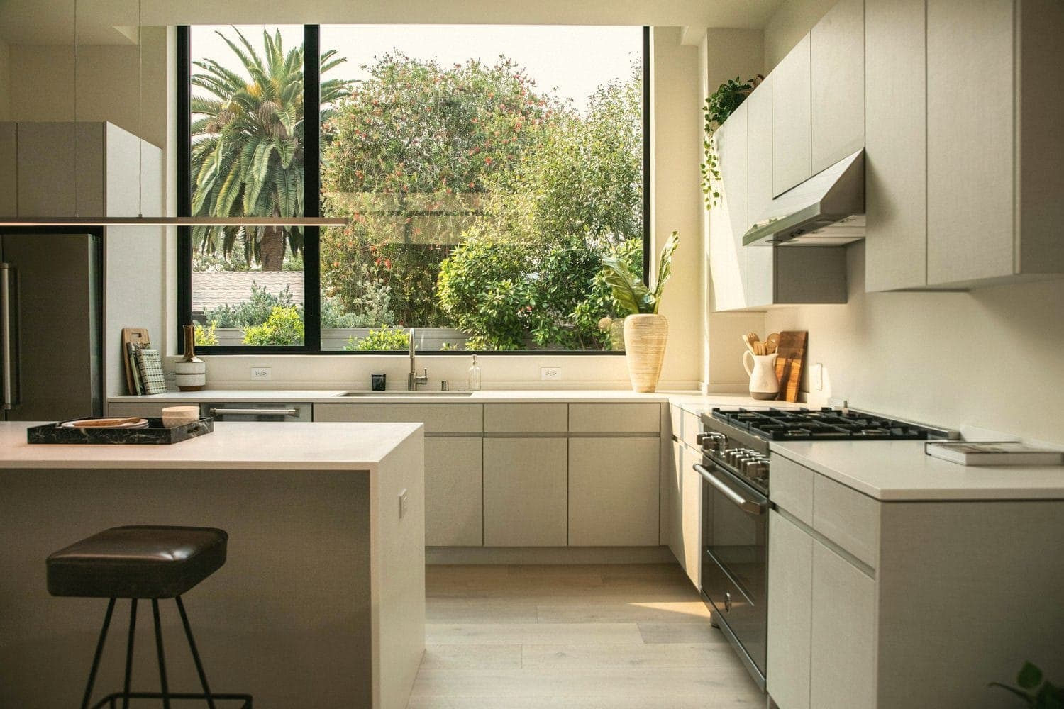 A modern kitchen with an island and a large window