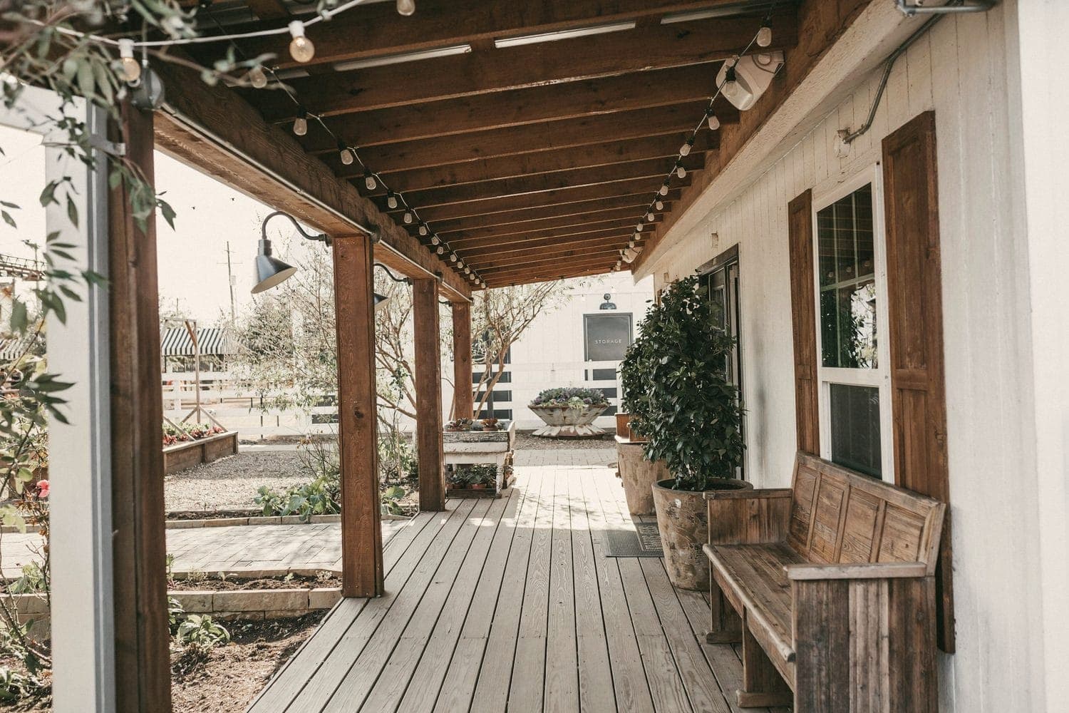 A covered wood porch with a bench
