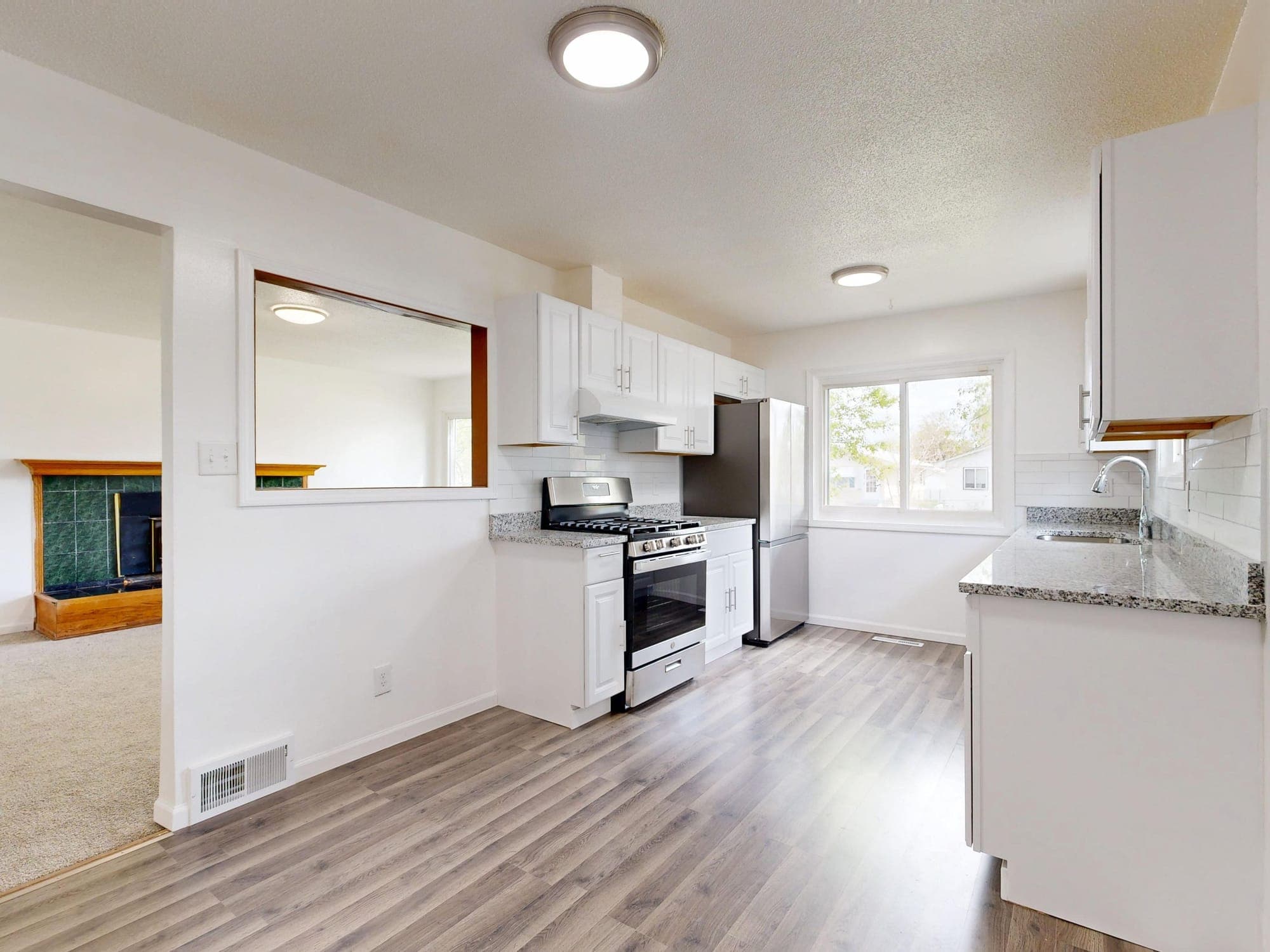 An empty white kitchen with new appliances